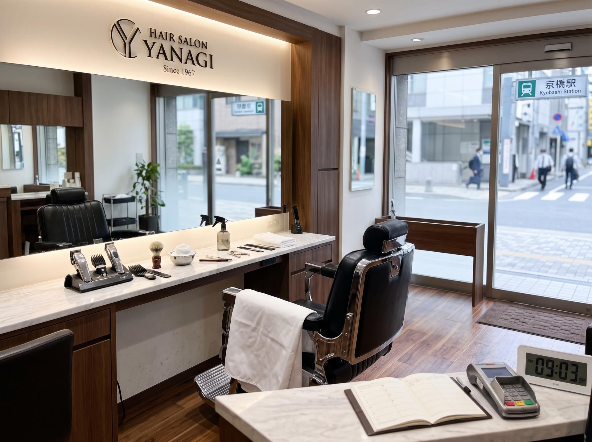 モダンなヘアサロンの店内、理容椅子と理髪用具、窓越しの京橋駅前の風景。